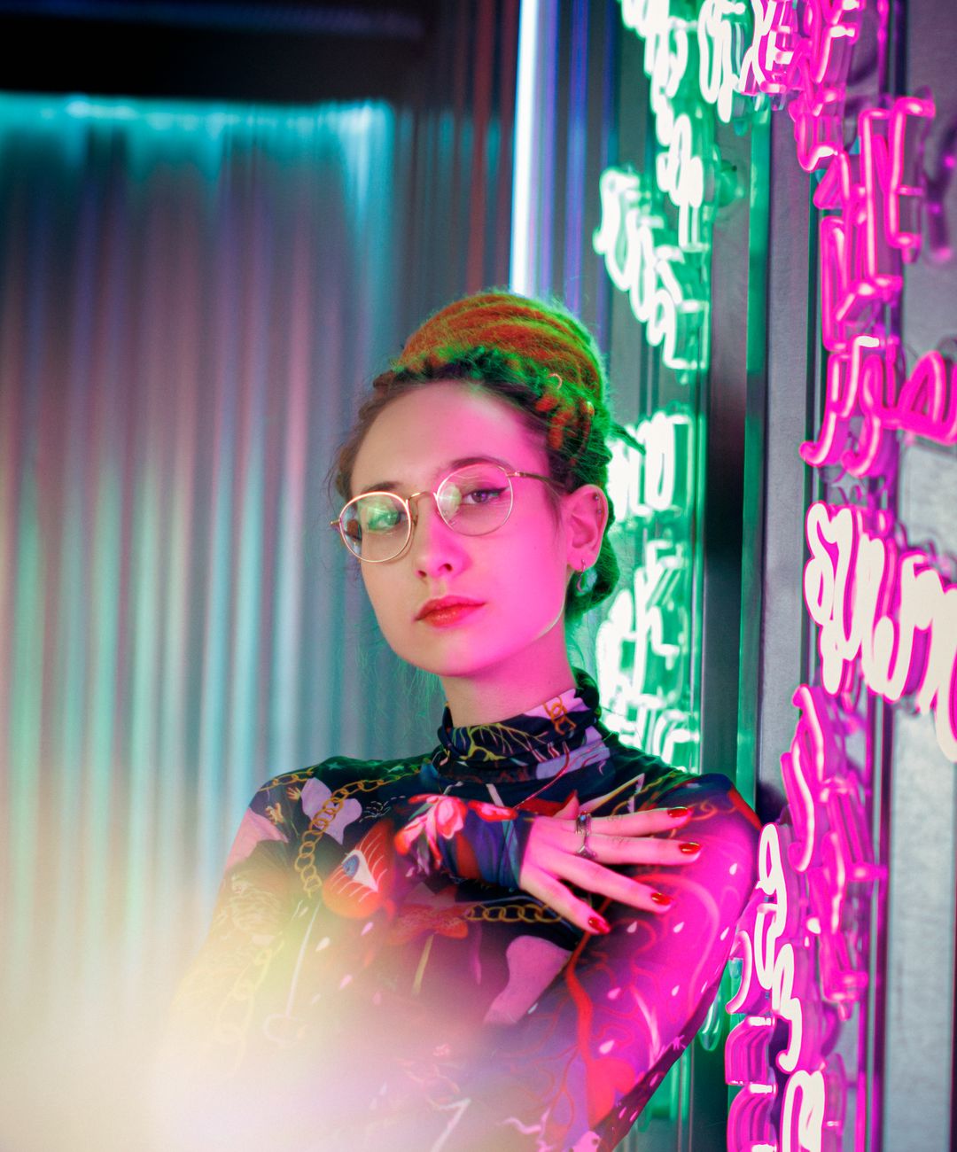 portrait of woman in neon lit room with glasses