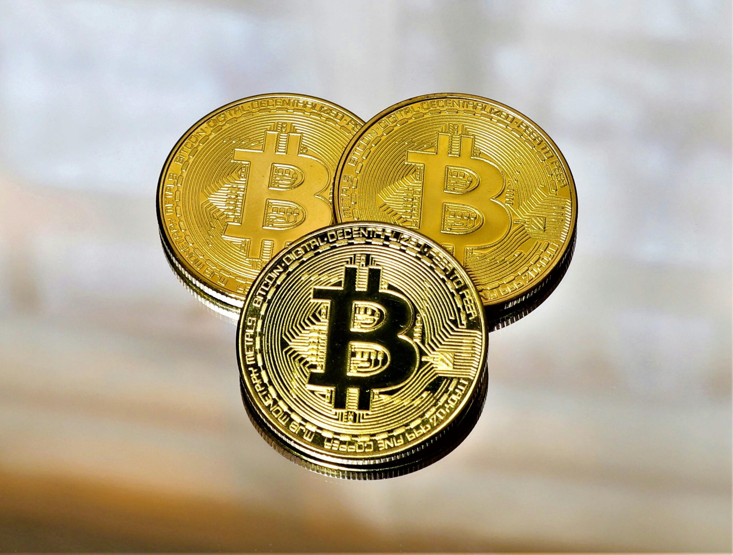 Gold Bitcoin coin in close-up under dim light, evoking patience and self-custody before the next Bitcoin Halving