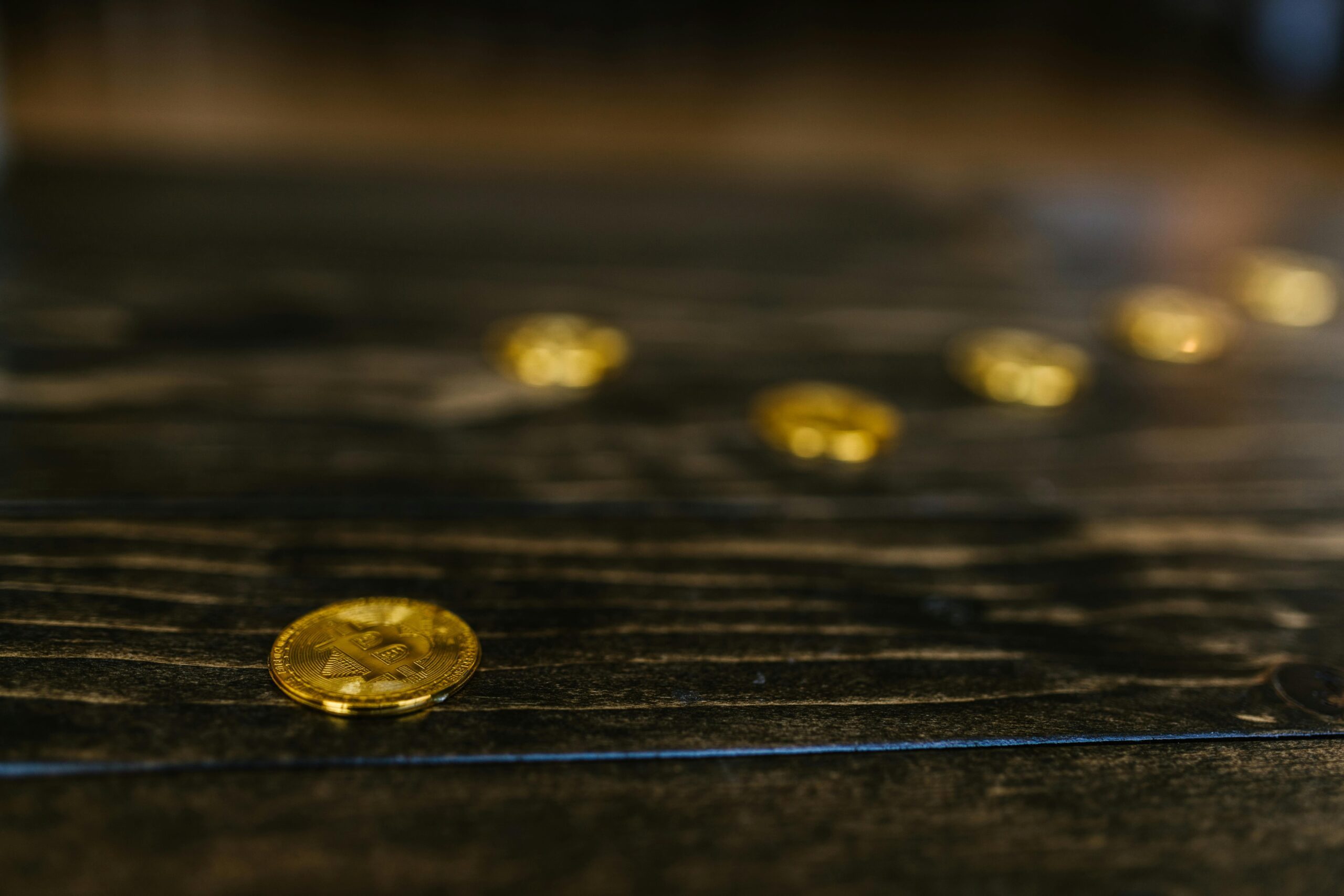 Dark monumental image of a bitcoin coin under a single low light