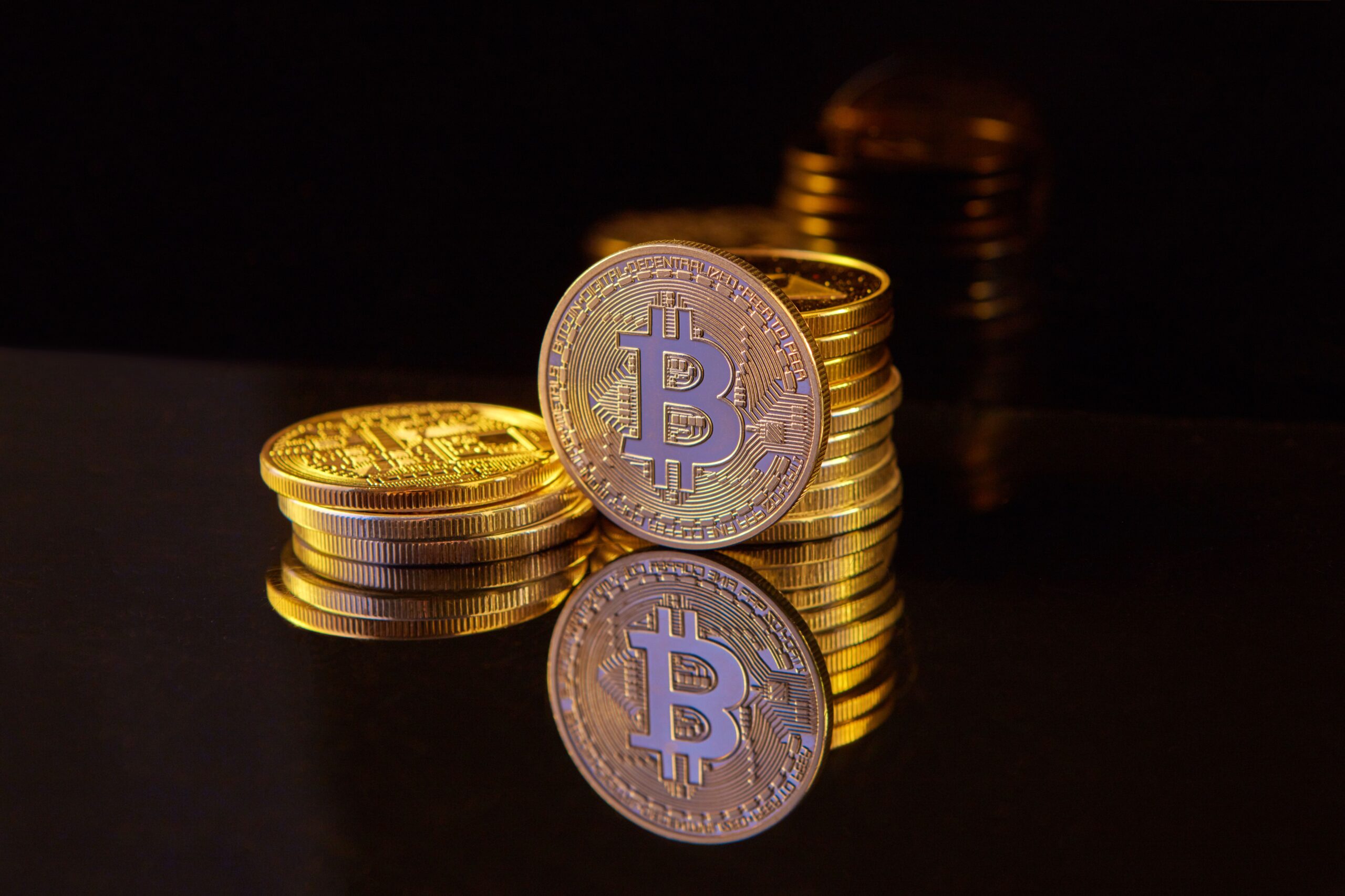 Close-up of golden Bitcoin coins arranged in a contemplative composition