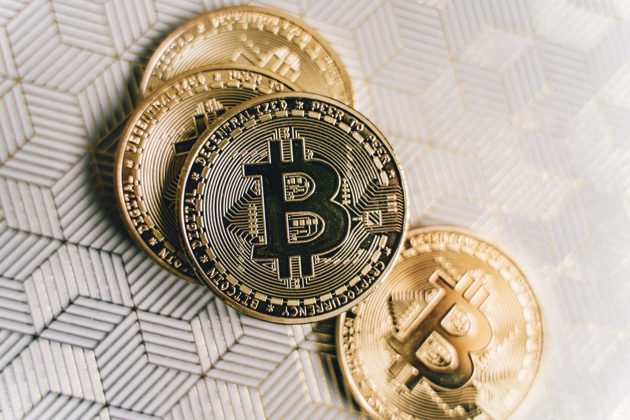A close-up of four Bitcoin coins, evoking a clock that has been right four times