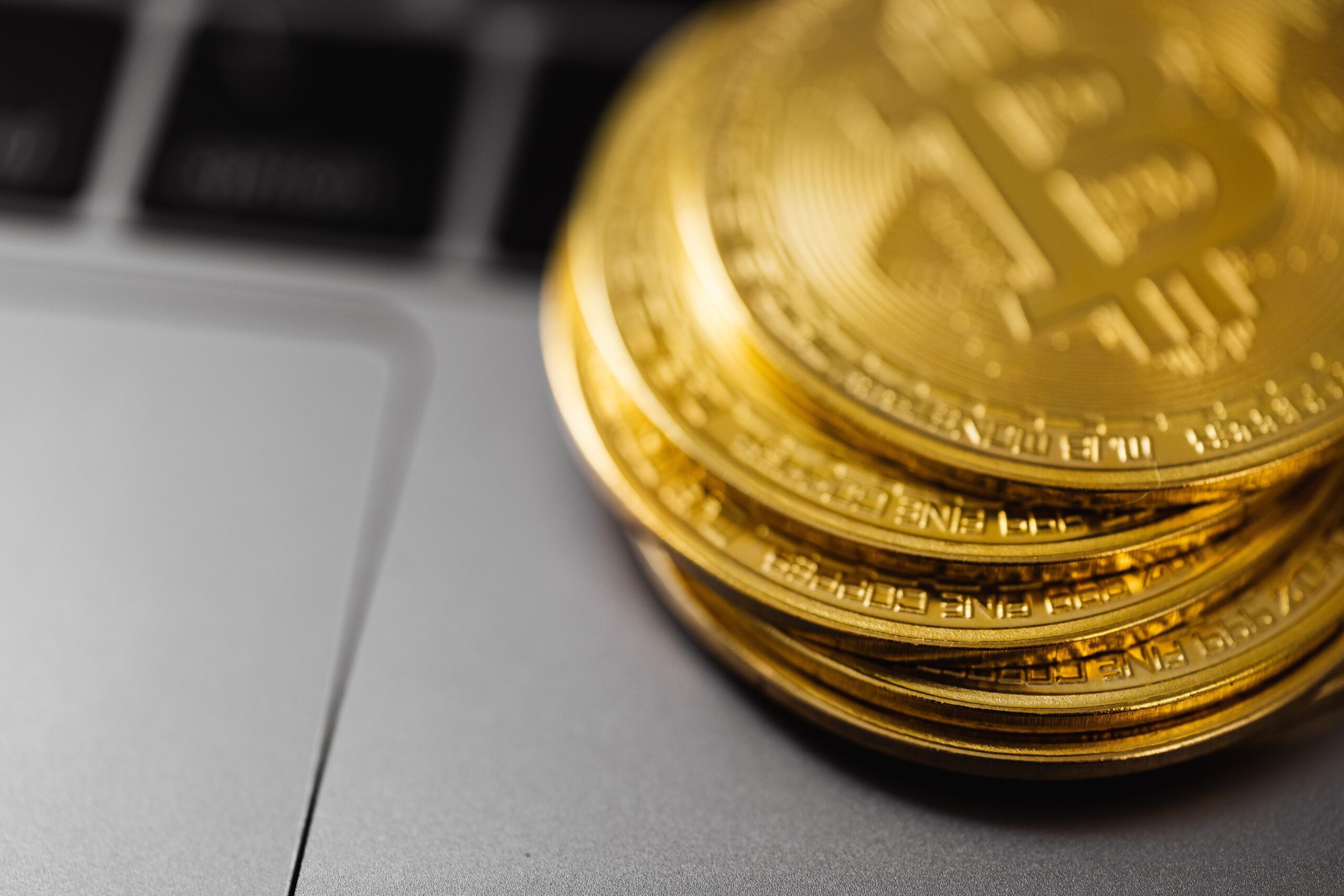 Close-up of bitcoins resting on a laptop, evoking dormant wallets and lost coins
