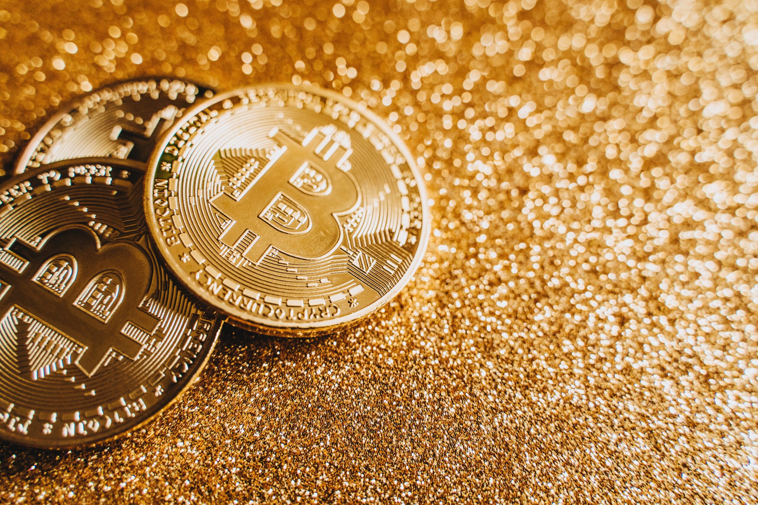 Close-up of gold coins on a dark surface, illustrating the Bitcoin Halving as a staircase that runs out of steps