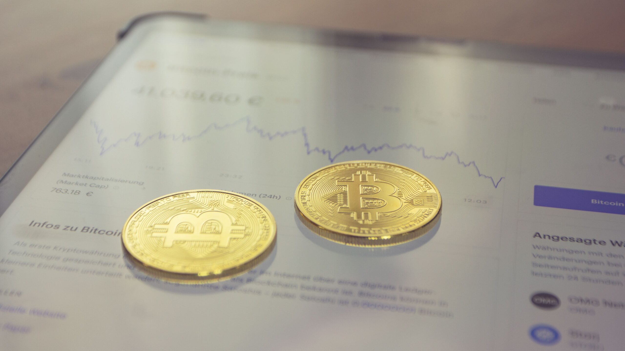 Close-up of golden Bitcoin coins on a dark surface