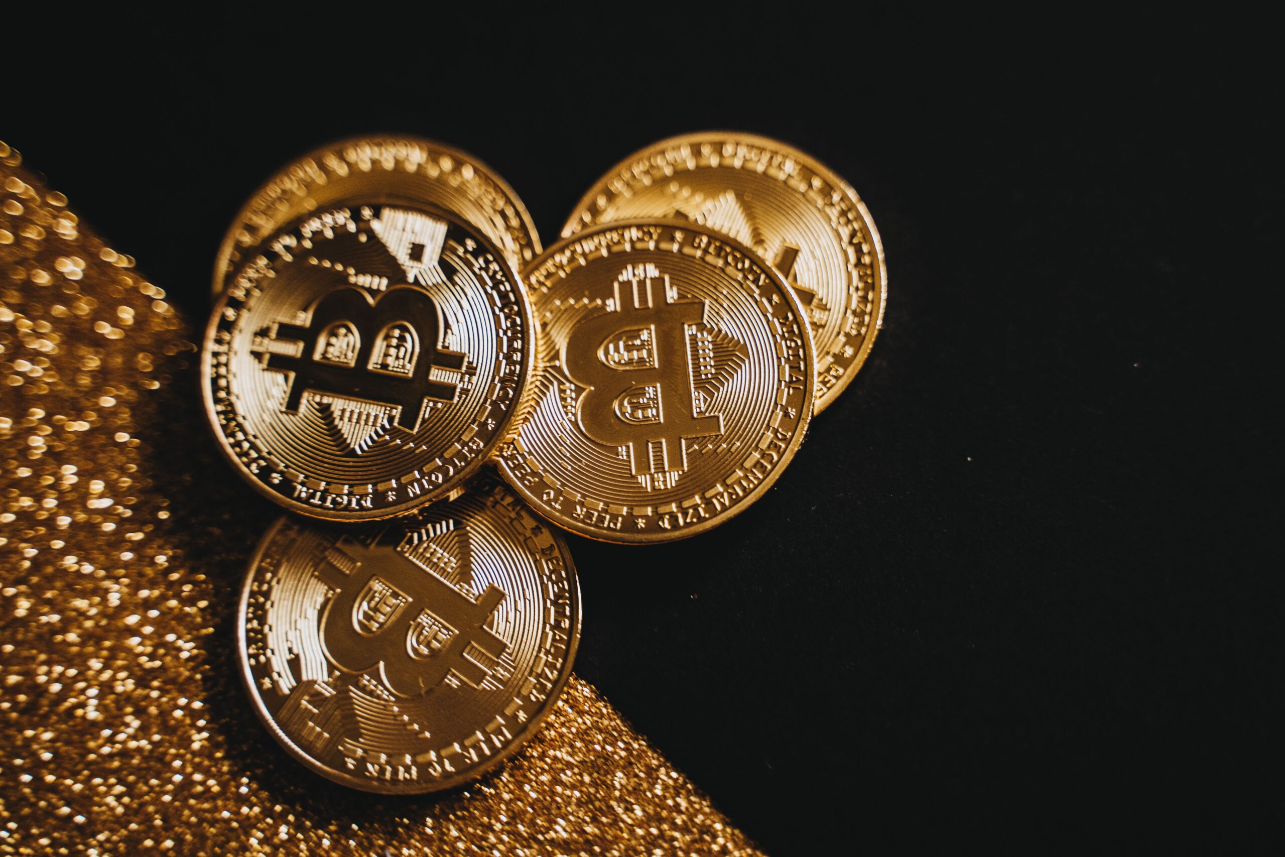Gold Bitcoin coin lit by a single light against a dark liturgical background
